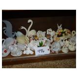 Shelf of small ceramic swan planters