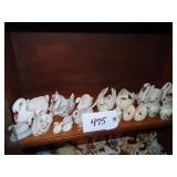 Shelf of small ceramic swan planters