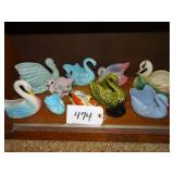 Shelf of small ceramic swan planters
