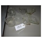 Assorted clear glass footed pitchers, covered swan