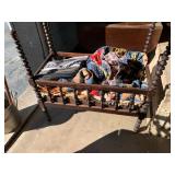 Antique wood toddler bed with quilts