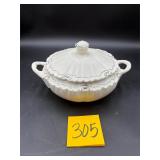 Vintage white porcelain soup tureen featuring a..