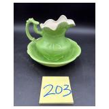 Pottery pitcher and wash basin set, featuring a..