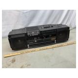 Portable Sharp X-Bass radio powers on