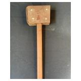 Primitive wooden hammer with leather strap as to