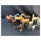 11 plastic toy horses   (damaged horse on