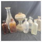 Group of glass bottles, Vase, and oil lamp base