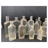 13 various glass bottles including Watkins