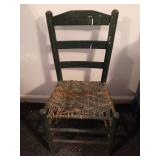 Wood chair painted green. Needs repairs on the