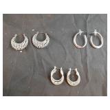 3 sets of silver in color earrings.