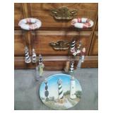 Lighthouse wind-chimes and a collectors plate of