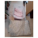 Plastic tote with towels and a reversible blanket