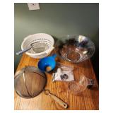 Strainers, plastic bowls, measuring cup, cake