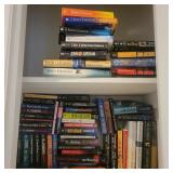 2 shelves of fiction novels mostly John Grisham