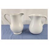2 white ceramic pitchers