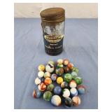 Vintage marbles in a snuff can