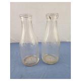 Vintage quart clear glass dairy bottles, one has