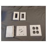 Misc white used outlet covers with some screws