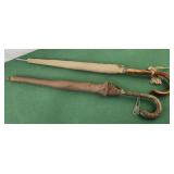 2 umbrellas tan and brown wood handles