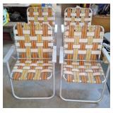 Set of 4 aluminum webbed foldable outdoor chairs.