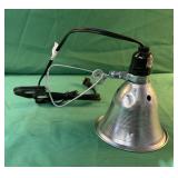 Clamp heat lamp up to 120V. Does work.