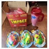 Paintballs, plastic travel mug, water balloon