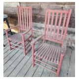 2 red wooden rocking chairs rockers