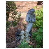 Yard decor including children, friar and a small
