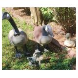 Yard decor including geese, child statue and a