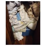 Linen closet contents including towels, sheets