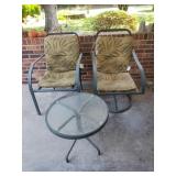 2 metal chairs and a round table