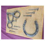 Antique horse bit, horseshoe and nails on burlap