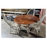 Table with 4 chairs, table top shows wear, table