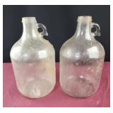 2 clear glass one gallon jugs
