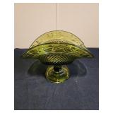 Curved pedestal green glass dish 8.5x5.5 has chip