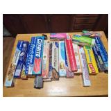 Opened assorted kitchen foil, parchment paper,