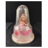 Vintage doll in a plastic display case. Doll is
