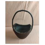Vintage round pottery basket with a stick handle
