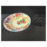 Plastic fruit bowl and black metal napkin holder