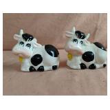 Vintage cow salt and pepper shakers set. 1 has a