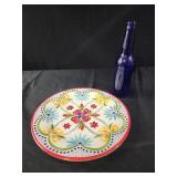 Plastic colorful plate, cobalt blue bottle