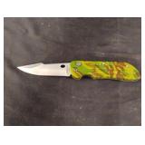 Camo switch blade pocket knife. Blade is 3" long