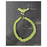 Peridot necklace and bird pin brooch