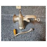 vintage, hand-cranked cast iron meat grinder.