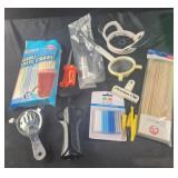 Assorted kitchen tools, skewers, straws, wine