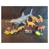 Assorted dinosaurs and shark toys, salamander