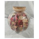 Large glass jar with cork lid filled with