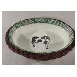 Vintage wicker basket holding a decorative cow