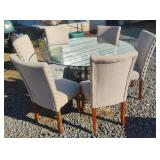 Metal and glass top table with 6 cloth chairs.
