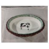 Vintage wicker basket holding a decorative cow